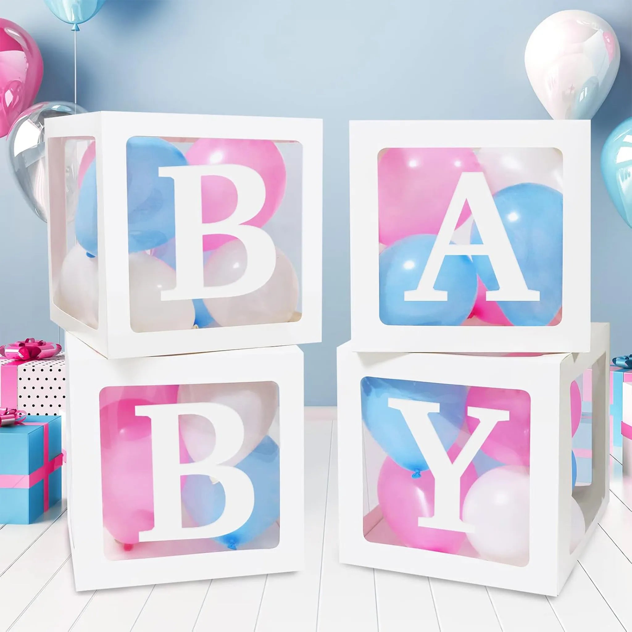 Stack of white blocks with 'BABY' letters surrounded by balloons and gifts on a light blue background