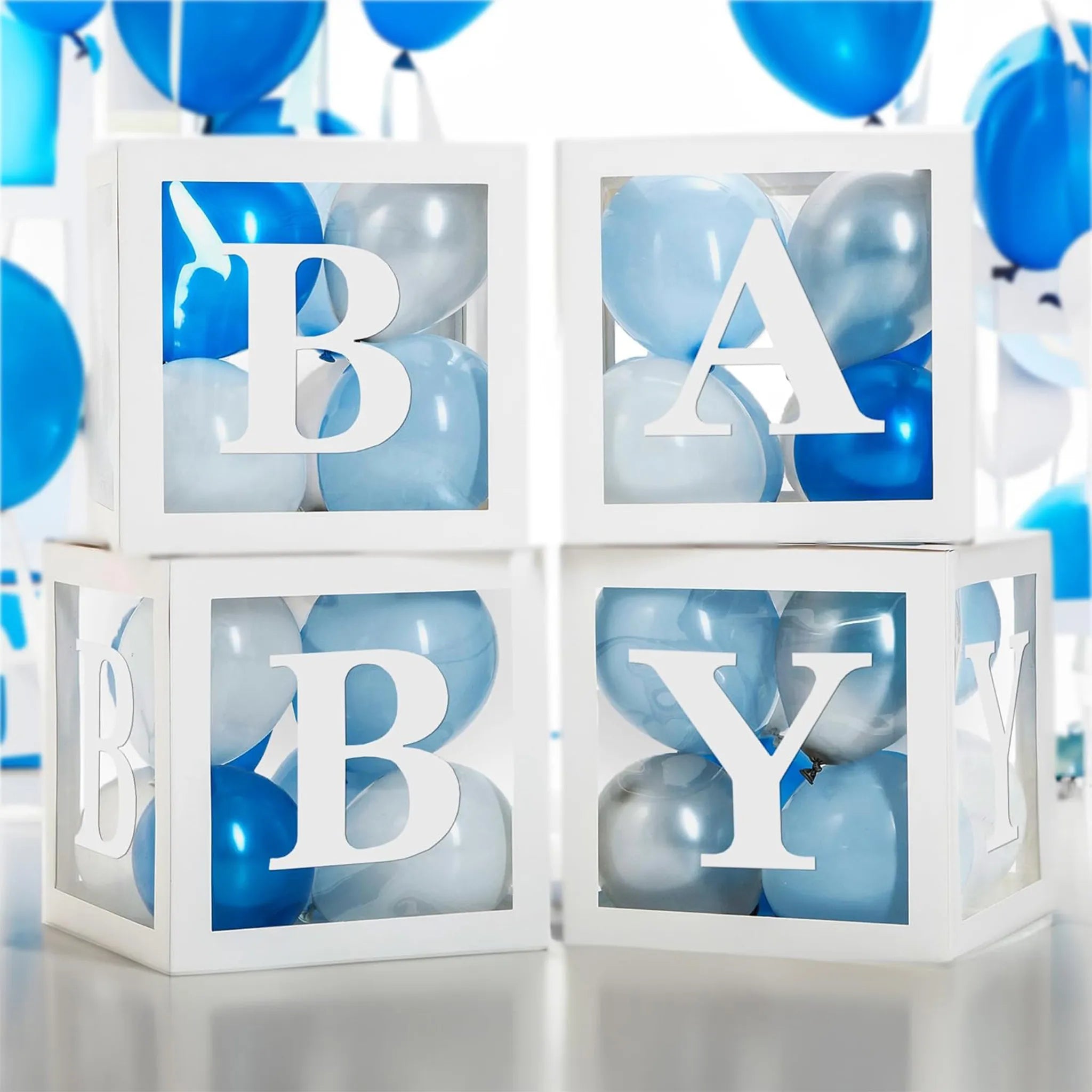 White letter blocks spelling 'BABY' with blue and gray balloons in a decorative setup.