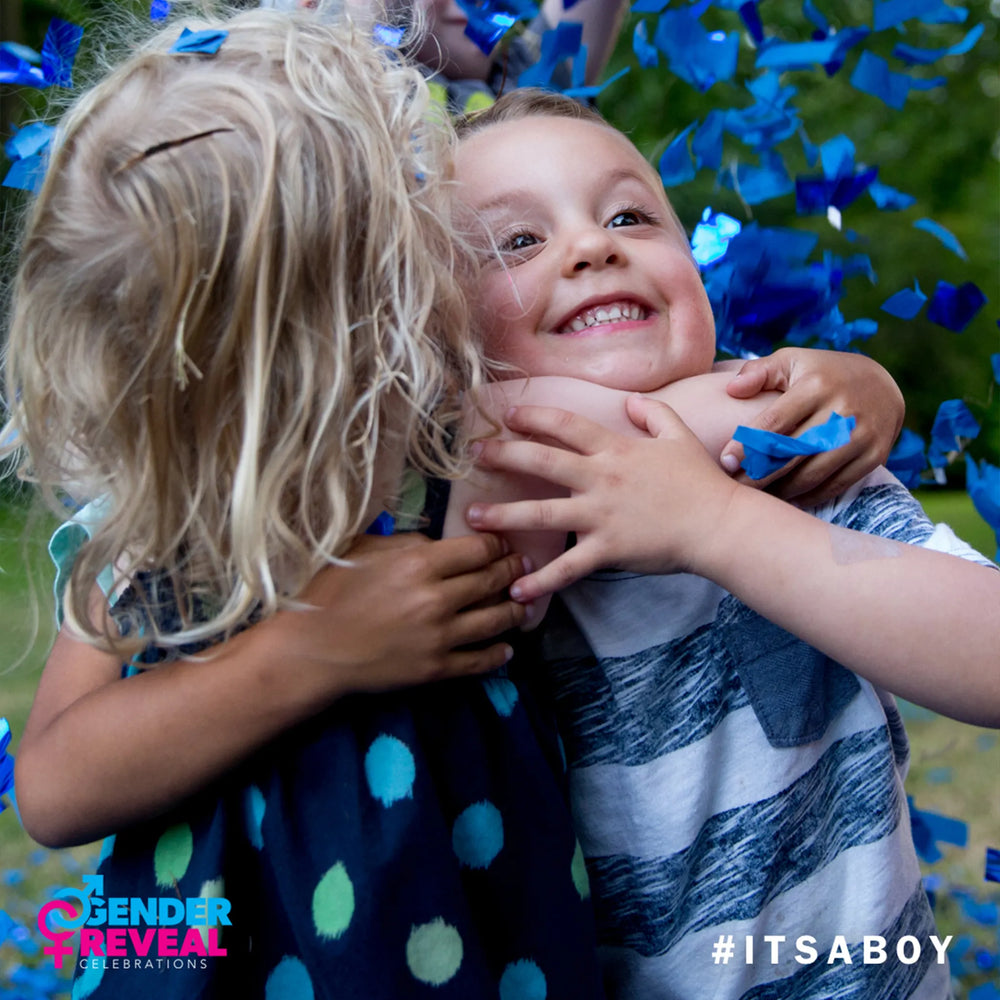Family popping blue gender reveal confetti cannons, it is a boy